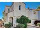 Inviting stucco home with an arched entry, attached garage, and carefully landscaped front yard at 6271 Sunset Spring Ave, Las Vegas, NV 89122