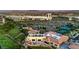 Picturesque community featuring commercial buildings, lush greenery, golf course and a scenic backdrop at 7625 Fieldfare Dr, North Las Vegas, NV 89084