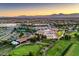 Expansive community with golf course, lush greenery, mountain views, surrounded by a vibrant cityscape at 7625 Fieldfare Dr, North Las Vegas, NV 89084