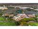 Stunning aerial shot of community with golf course, lush greenery, commercial buildings and mountain views at 7625 Fieldfare Dr, North Las Vegas, NV 89084
