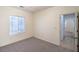 Well-lit bedroom featuring carpeting, bright window, and view of the outdoor space at 7625 Fieldfare Dr, North Las Vegas, NV 89084