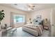 Relaxing bedroom featuring a large window, a comfortable bed, and soft, natural light at 7625 Fieldfare Dr, North Las Vegas, NV 89084