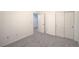 Comfortable bedroom featuring carpeting and a closet with sliding doors, and view to hall at 7625 Fieldfare Dr, North Las Vegas, NV 89084