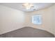 Bright bedroom with neutral walls, plush carpeting, and a ceiling fan at 7625 Fieldfare Dr, North Las Vegas, NV 89084