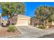 Charming single-story home featuring desert landscaping, a spacious driveway, and a two-car garage at 7625 Fieldfare Dr, North Las Vegas, NV 89084