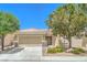 Inviting single-story home features a two-car garage, well-maintained landscaping, and a charming facade at 7625 Fieldfare Dr, North Las Vegas, NV 89084