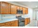 A stainless-steel stove and microwave complement oak cabinets in this efficiently designed kitchen at 7625 Fieldfare Dr, North Las Vegas, NV 89084