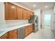 Well-lit kitchen featuring stainless steel appliances, plenty of cabinets, and tile flooring at 7625 Fieldfare Dr, North Las Vegas, NV 89084