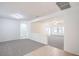 Bright and airy living room with neutral carpeting, fresh white paint, and an open concept layout at 7625 Fieldfare Dr, North Las Vegas, NV 89084