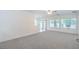 Spacious living room with natural light, ceiling fan, and neutral color palette at 7625 Fieldfare Dr, North Las Vegas, NV 89084