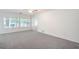 Large living room with big windows and neutral carpet and paint at 7625 Fieldfare Dr, North Las Vegas, NV 89084