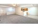 Open living space features neutral carpeting, an adjacent breakfast bar, and easy kitchen access at 7625 Fieldfare Dr, North Las Vegas, NV 89084