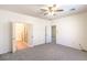 Spacious main bedroom featuring ceiling fan with access to bathroom at 7625 Fieldfare Dr, North Las Vegas, NV 89084