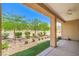 Inviting covered patio with manicured landscaping and decorative plants at 7625 Fieldfare Dr, North Las Vegas, NV 89084