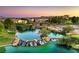Scenic community pond with cascading waterfall, lush landscaping, and beautiful homes in the background at 7625 Fieldfare Dr, North Las Vegas, NV 89084