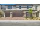 Charming two-story townhome featuring a two-car garage, brick accents, and neutral color palette at 8401 Waterwood St, Las Vegas, NV 89166