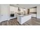 Modern kitchen features white cabinets, stainless appliances, and a large center island at 8401 Waterwood St, Las Vegas, NV 89166