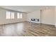 Spacious living room featuring hardwood floors, large windows, and a modern fireplace at 8401 Waterwood St, Las Vegas, NV 89166