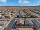 An aerial view highlights the layout of a residential area with multiple homes, streets, and mountain views in the background at 400 S Jena St, Henderson, NV 89015