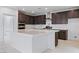 Modern kitchen featuring white countertops, stainless steel appliances, and dark wood cabinets at 400 S Jena St, Henderson, NV 89015