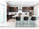 Bright kitchen featuring an island with seating, stainless steel appliances, and modern dark wood cabinetry at 400 S Jena St, Henderson, NV 89015