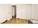 Bedroom with neutral-toned tiled floor features a closet and two doors at 425 Oil Lantern Ln, Las Vegas, NV 89145