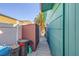 Exterior alleyway includes storage shed and trash bins along the side of home at 425 Oil Lantern Ln, Las Vegas, NV 89145