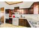 Traditional kitchen features dark cabinets, light countertops, and updated appliances at 425 Oil Lantern Ln, Las Vegas, NV 89145