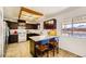 Open concept kitchen with breakfast bar, stainless steel appliances, and dark wood cabinetry at 425 Oil Lantern Ln, Las Vegas, NV 89145