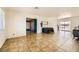 Spacious living room with tile floors, access to backyard, and neutral paint at 425 Oil Lantern Ln, Las Vegas, NV 89145