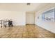 Spacious living room with tile flooring, bright lighting, and multiple access points at 425 Oil Lantern Ln, Las Vegas, NV 89145