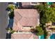 Birds-eye view of a home showcasing its backyard, patio area, and surrounding landscaping with a classic tile roof at 10105 Shore Pine Ave, Las Vegas, NV 89129