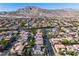 Extensive aerial view displays neighborhood's winding streets, lush green trees, and mountain views enhancing the property's appeal at 10105 Shore Pine Ave, Las Vegas, NV 89129