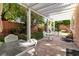 Covered patio with backyard featuring mature trees and landscaping at 10105 Shore Pine Ave, Las Vegas, NV 89129