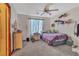 Comfortable bedroom featuring a ceiling fan, window with curtains, and ample space at 10105 Shore Pine Ave, Las Vegas, NV 89129