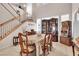 Formal dining room with stairs, cabinet, and slot machine adding a unique touch to the space at 10105 Shore Pine Ave, Las Vegas, NV 89129