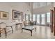 Bright living room with tile floors, tall windows, and comfortable seating arrangements for a cozy atmosphere at 10105 Shore Pine Ave, Las Vegas, NV 89129