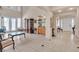Open-concept living room with tiled floors, and high ceilings allowing plenty of natural light at 10105 Shore Pine Ave, Las Vegas, NV 89129