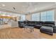 Open-concept living room with hardwood flooring and natural light flowing through large windows at 10105 Shore Pine Ave, Las Vegas, NV 89129