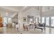 Spacious living room with high ceilings, tiled flooring, and lots of natural light from large windows at 10105 Shore Pine Ave, Las Vegas, NV 89129