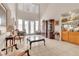 Large living room with tiled flooring, tall windows, and furniture arrangements conducive to conversation at 10105 Shore Pine Ave, Las Vegas, NV 89129