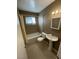 Neutral bathroom features a shower-tub combo, tile flooring, standard toilet, and single sink vanity at 2516 E Mesquite Ave, Las Vegas, NV 89101
