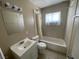Bathroom with tub-shower combo, single sink vanity, and tile floors at 2516 E Mesquite Ave, Las Vegas, NV 89101
