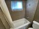Bathroom features a shower-tub combo with tile surround and window at 2516 E Mesquite Ave, Las Vegas, NV 89101