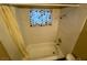 Cozy bathroom featuring a tub with white tile surround and window at 2516 E Mesquite Ave, Las Vegas, NV 89101