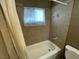 Bathroom features a shower-tub combo with tile surround and window at 2516 E Mesquite Ave, Las Vegas, NV 89101