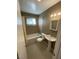 Bathroom features a shower-tub combo, sink, toilet and neutral colored tile at 2516 E Mesquite Ave, Las Vegas, NV 89101