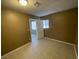 This bedroom features neutral walls, tile floors, and a door to another room at 2516 E Mesquite Ave, Las Vegas, NV 89101