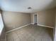 Neutral room with tile flooring featuring a window and doorway at 2516 E Mesquite Ave, Las Vegas, NV 89101