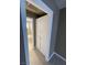 A hallway with a bathroom at the end of the hallway and cabinets on the right wall at 2516 E Mesquite Ave, Las Vegas, NV 89101